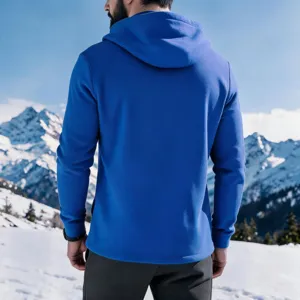 Back view detail of royal blue fleece lined hoodie with hood in snowy mountain scene.