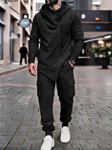 Men's black asymmetrical zip hoodie and cargo trousers set street style detail view.