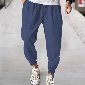 Detail view of casual blue men pants featuring comfortable cuffed hems and adjustable drawstring.