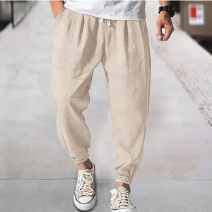 Casual mens breathable linen trousers with elastic drawstring waist and cuffed hem in beige.