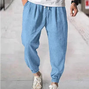 Men's casual loose fit light blue joggers with elastic cuffs and convenient drawstring waist.