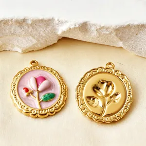 Close-up detail of gold-plated tulip pendants with enamel and embossed floral design