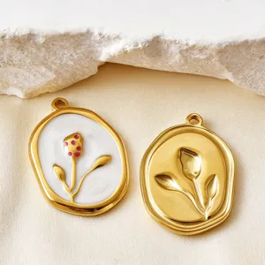 Close-up of stainless steel tulip flower charms with enamel and gold embossed details.