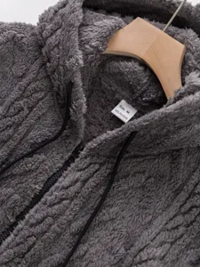 Close-up of mens fleece zip-up hooded sweatshirt texture detail in dark gray.