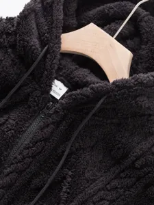 Close-up of men's fuzzy sherpa fleece zip-up hoodie texture detail and collar tag.