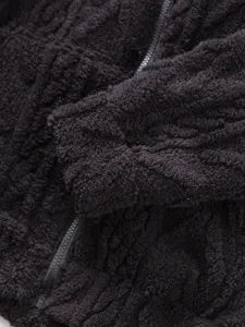 Men's fleece jacket detail view showcasing soft textured fabric and zipper closure design.