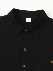 Close-up of black men's casual linen blend shirt collar detail showcasing fine texture.