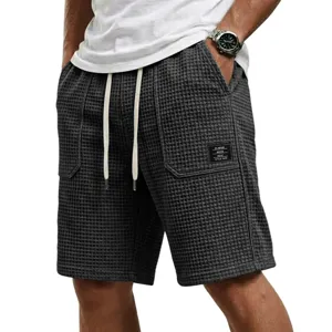 Men's casual waffle knit shorts with elastic drawstring waist and pockets for summer beach wear.