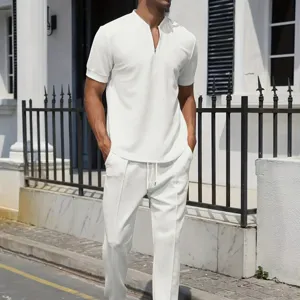 Detailed view of white waffle knit short sleeve zip polo shirt and casual pants set.