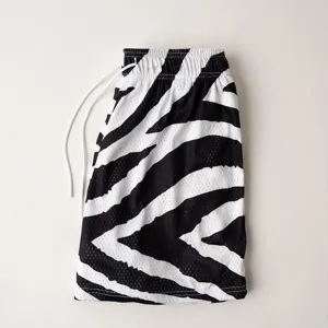 Detail view of men's athletic zebra print mesh shorts with white drawstring for casual wear.