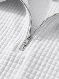 Close up view of white waffle knit fabric detail with metal zipper for men casual apparel.