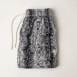 Detailed view of men's casual sports shorts featuring bold snakeskin digital print and drawstring waist.