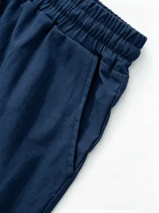 Men's casual linen shorts detail, featuring elastic waistband and side pocket design.