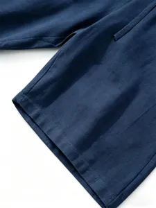Close-up detail of mens cotton linen shorts showing fine stitching fabric texture and drawstring.
