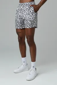 Men's athletic shorts detail showing bold black and white print and drawstring waistband.