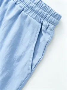 Close-up detail of mens light blue linen cotton shorts elastic waist pocket craftsmanship.
