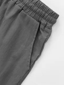 Men's casual linen shorts detail shot, showing elastic waistband and pocket design, comfortable.
