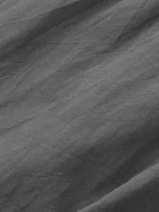 Close-up detail of breathable dark gray linen fabric texture showing natural weave.