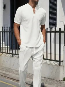 Men's white waffle knit short sleeve zip polo shirt and casual long pants set for summer.