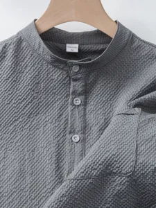 Grey textured stand collar short sleeve shirt fabric detail view, comfortable casual menswear.