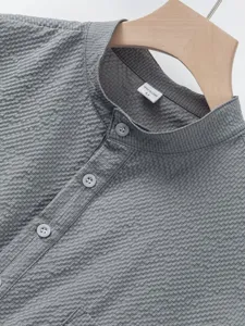 Detail view of men's casual mandarin collar shirt featuring unique grid texture fabric.
