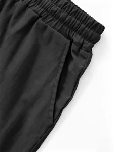 Detailed view of men's casual linen shorts, elastic waistband, and side pocket texture.