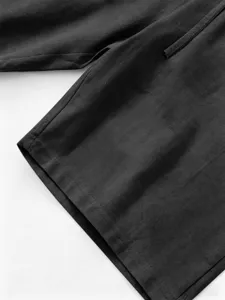 Dark grey linen shorts detail view, featuring soft breathable fabric and fine stitching.