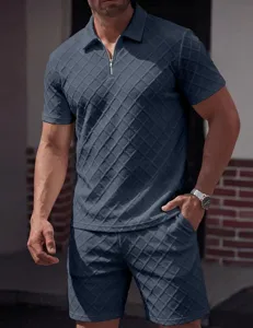 Detail shot of men's dark blue jacquard knit polo shirt and shorts set with zipper collar.