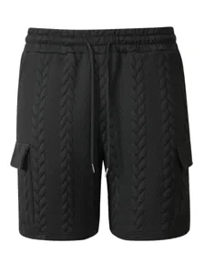 Close-up detail of black men's casual shorts featuring textured jacquard fabric and drawstring.