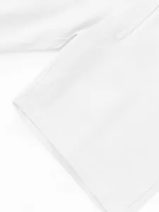 Men's casual solid color linen shorts detail view, breathable summer beach trouser hem.
