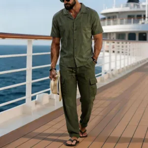 Detailed view of men's casual green linen short sleeve shirt and long pants set for summer.
