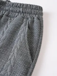 Grey mens casual shorts detail shot, textured jacquard fabric, elastic waistband pocket.