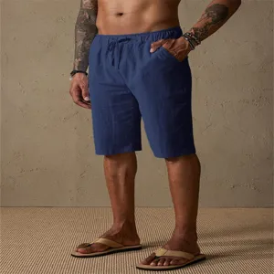 Detailed view of men's casual cotton linen shorts with drawstring waist and deep blue solid color.