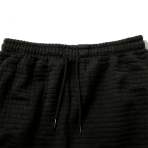 Waffle knit sweatpants detail shot showcasing textured fabric and adjustable drawstring waist.