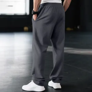 Detailed back view of men's casual sweatpants in dark gray, comfortable relaxed fit style.