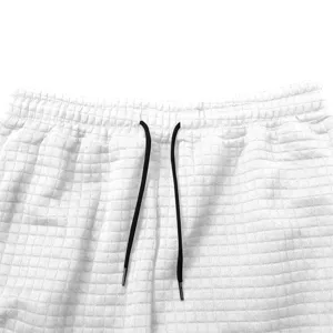 Detailed close-up view of white waffle knit men sweatpants elastic waistband with black drawstring.