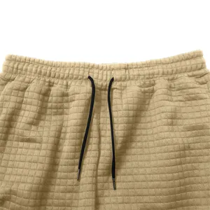 Men's waffle knit sweatpants detail shot featuring elastic waist and adjustable drawstring.