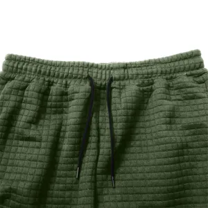 Dark green waffle knit sweatpants elastic drawstring waistband detail closeup view