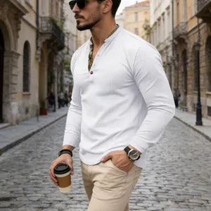 Detailed view of men's white waffle knit long-sleeve henley shirt with contrast placket.
