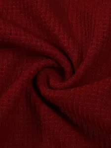 Close-up fabric detail showing dark red waffle knit texture, soft thermal material surface.