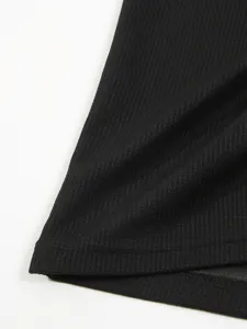 Detailed close-up view of the black waffle knit fabric and clean stitching of the shirt.