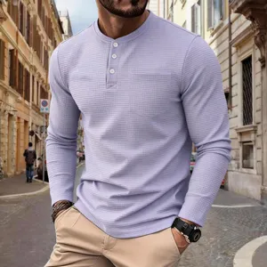 Men's waffle knit long sleeve Henley shirt with button placket and chest pocket detail.