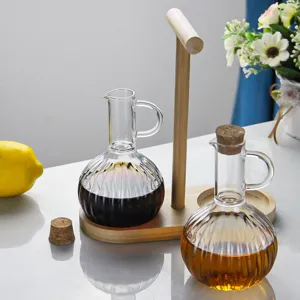 Glass oil bottle set with wooden tray and cork stopper, perfect for kitchen liquid condiments.