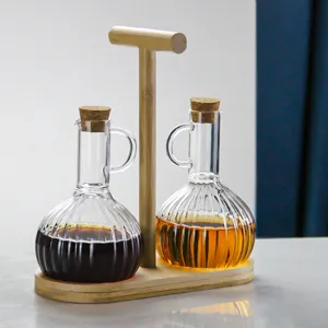 Glass oil and vinegar dispenser set with natural wooden stand, perfect for kitchen seasoning.