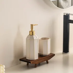 Minimalist ceramic bathroom liquid soap dispenser and cup set on wooden tray detail view