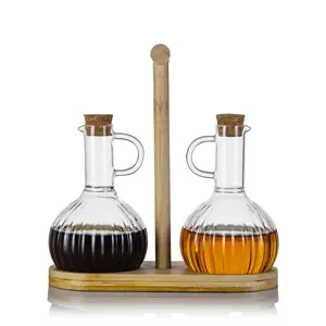 Clear glass oil bottle detail view with bamboo wooden tray and cork stopper, kitchen seasoning set.
