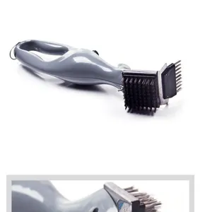 Stainless steel BBQ cleaning brush detail view, showing durable bristles and scraper head for grills.