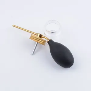 Molecular gastronomy powder spray bottle detail shot showcasing the rubber bulb and metal tube.