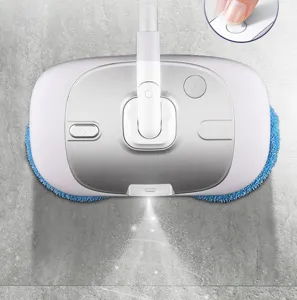 Detail view of cordless electric spray mop head spraying water on grey floor, button close-up.