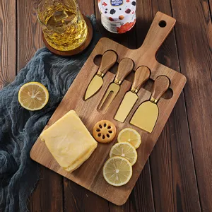 Vista detallada de la tabla de quesos de madera con cuchillos para cortar fruta y mantequilla.
